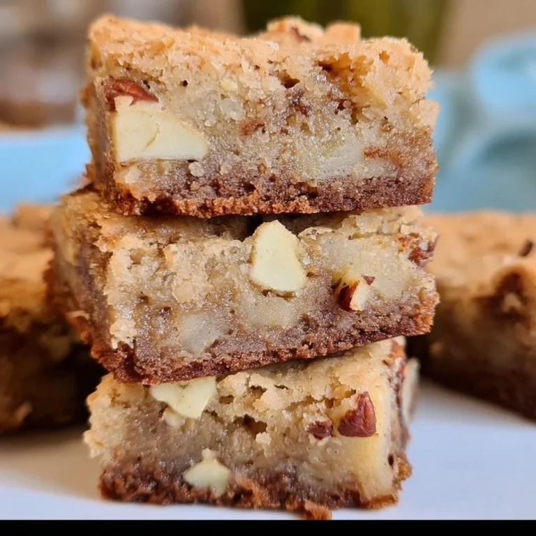 Delicious homemade apple brownies topped with fresh apple slices and nuts.