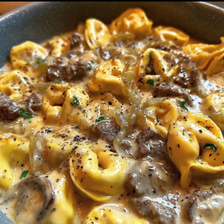 Delicious cheesesteak tortellini in creamy provolone sauce served in a bowl