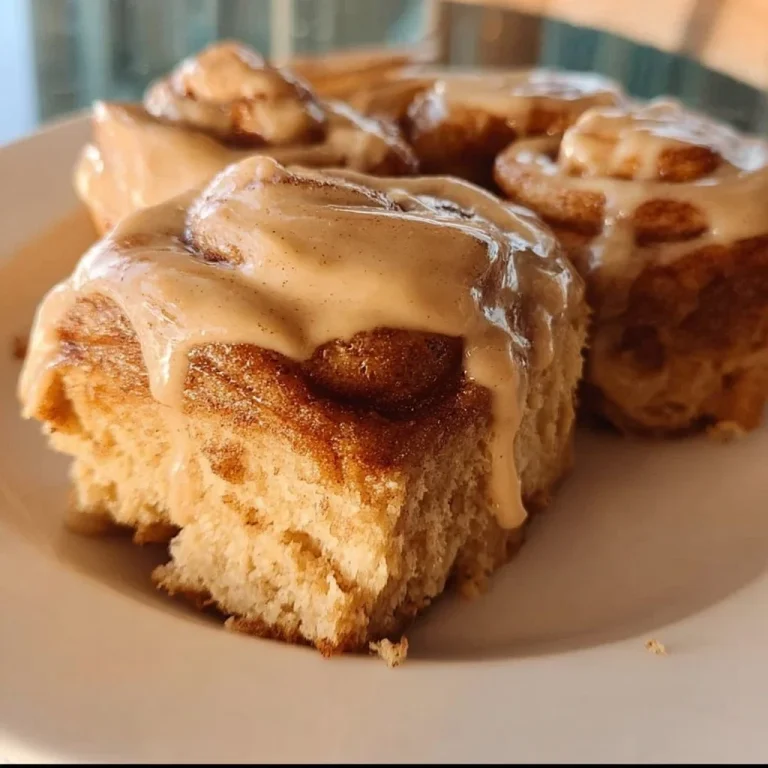Delicious gingerbread cinnamon rolls topped with icing and festive spices