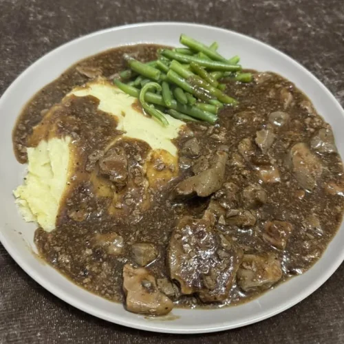 Savory liver mash served with creamy mashed potatoes and tender green beans.