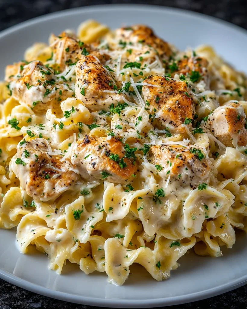 Slow Cooker Creamy Chicken Alfredo served in a bowl with parsley garnish
