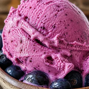 Delicious bowl of blueberry frozen yogurt topped with fresh blueberries