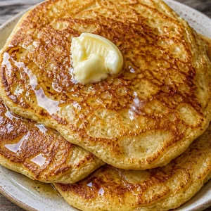 Delicious easy cottage cheese banana pancakes stacked on a plate