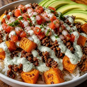 Ground Beef Sweet Potato Taco Bowl with Lime Crema topped with fresh ingredients