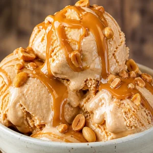 Delicious bowl of Peanut Butter Frozen Yogurt topped with chocolate and nuts