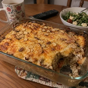 Creamy chicken and wild rice bake in a casserole dish, garnished with herbs.